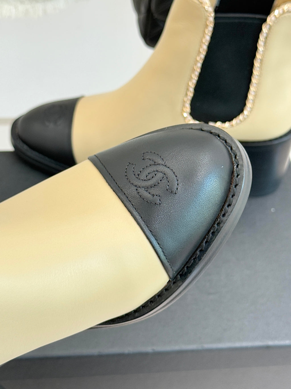 Women’s chelsea boot toe, cream upper with black leather panel and Chanel emblem