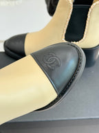 Women’s chelsea boot toe, cream upper with black leather panel and Chanel emblem