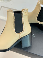 Women’s chelsea ankle boots, cream leather with black heel and Chanel logo patch