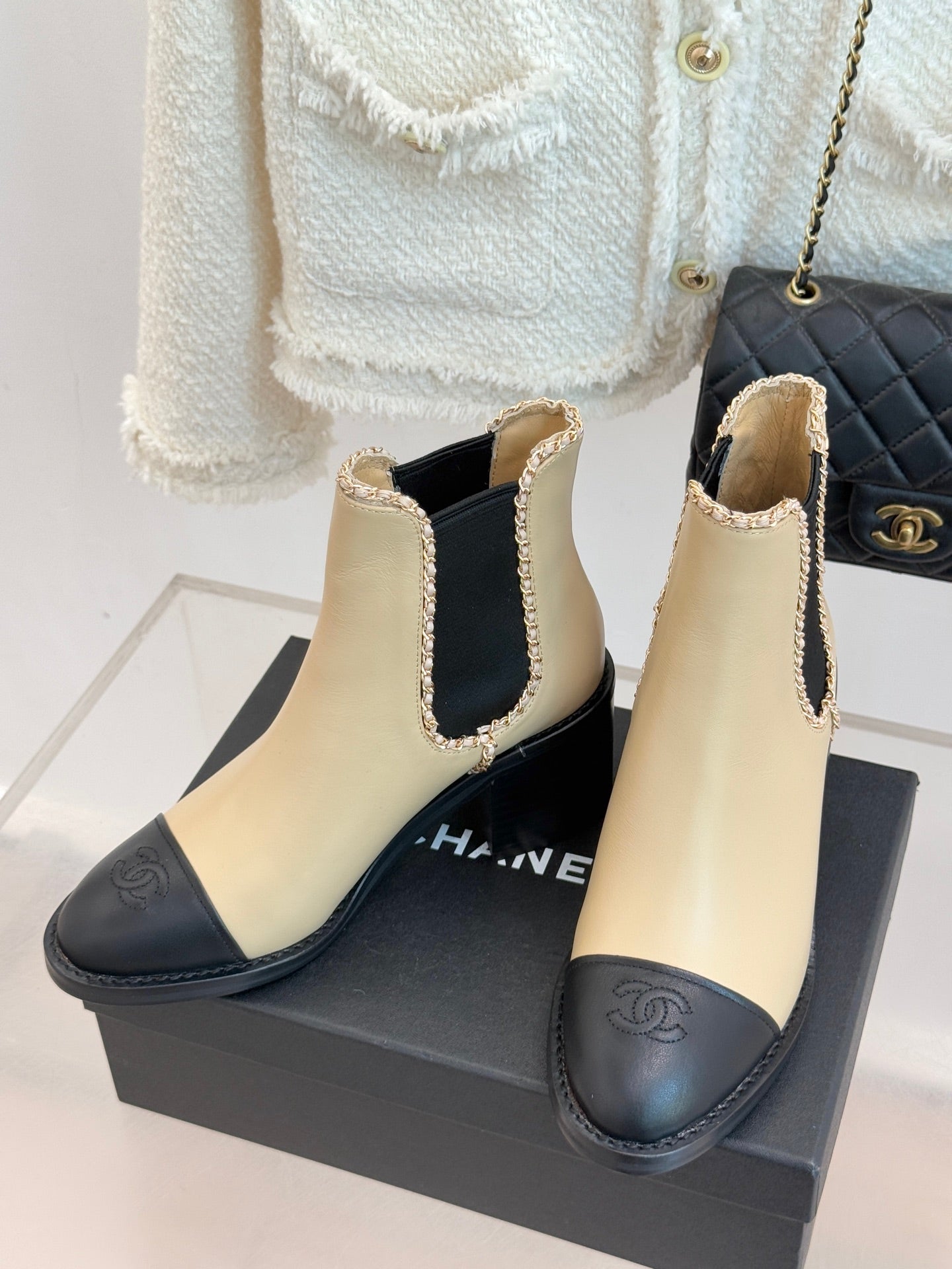 Women’s chelsea ankle boots, cream upper with black side panel and chain trim