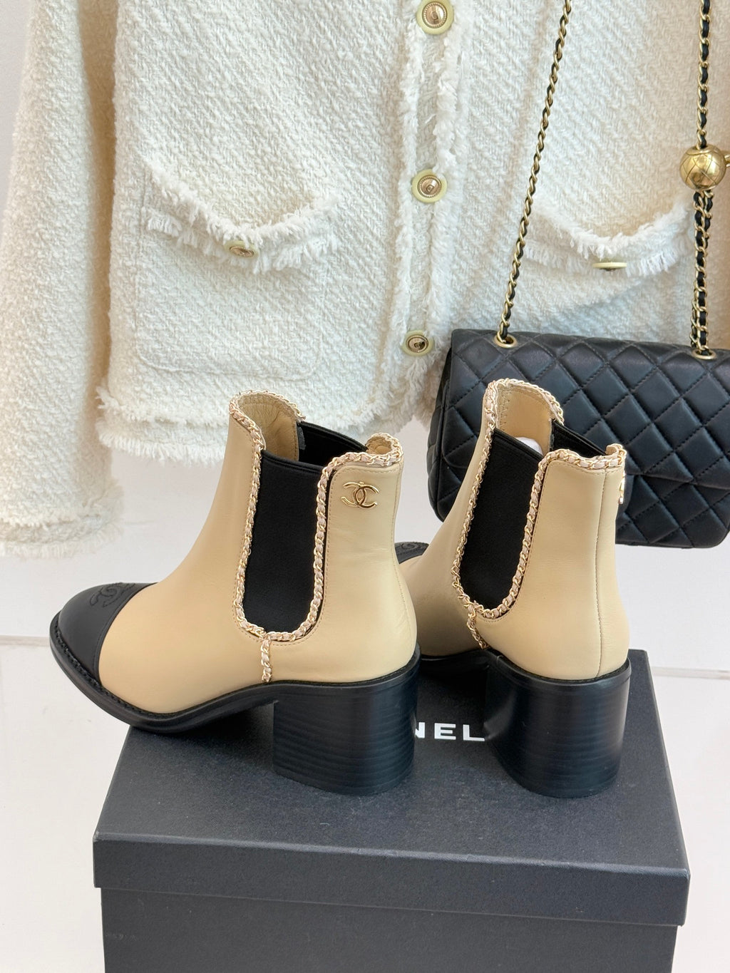Women’s chelsea boots, cream leather with black heel and side Chanel emblem