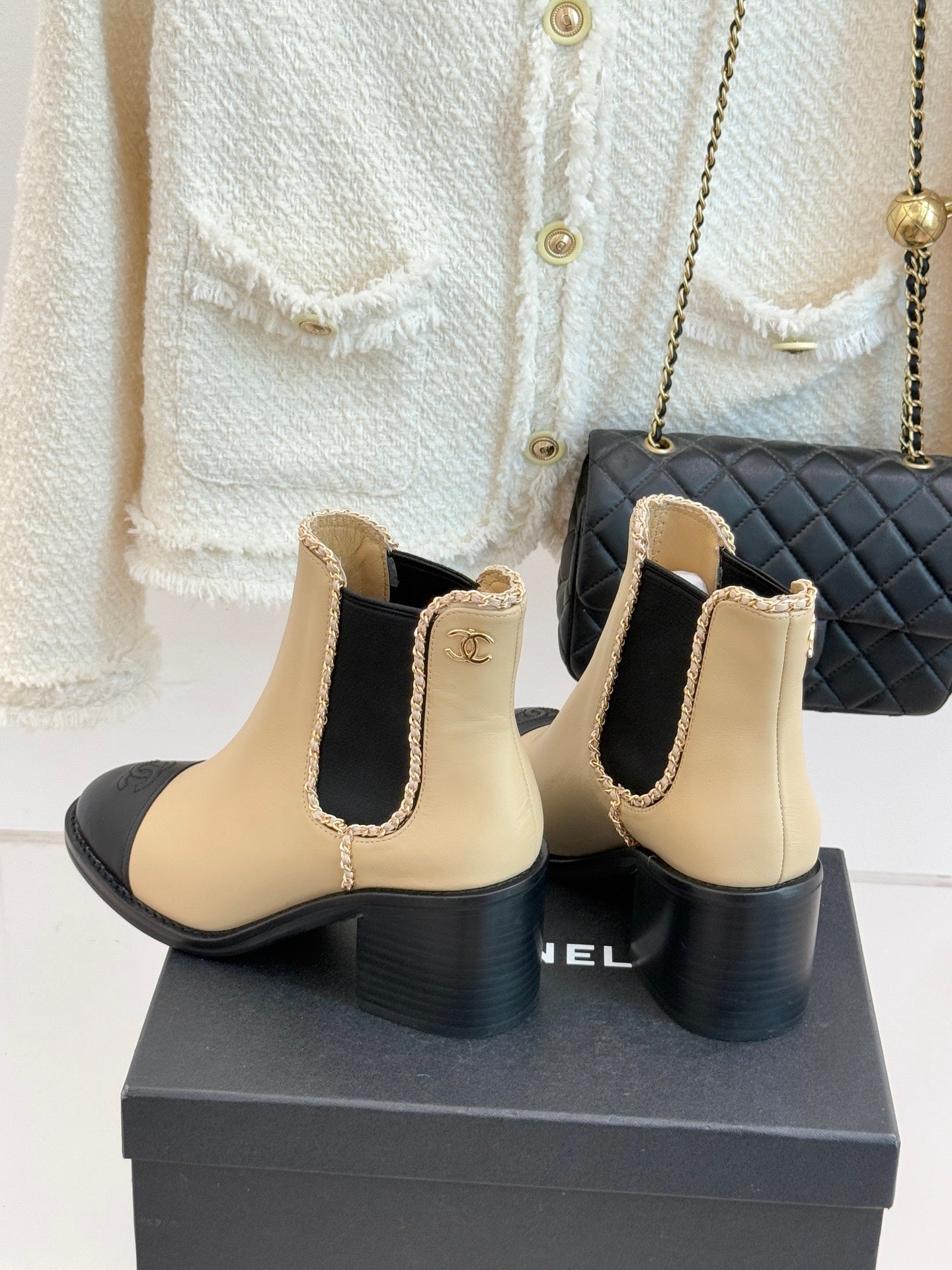 Women’s chelsea boots, cream leather with black heel and side Chanel emblem