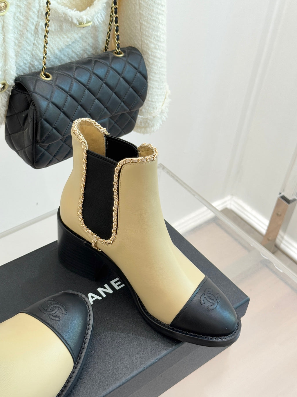 Women’s chelsea boots with cream leather and black quilted-style toe detail