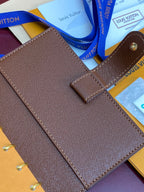 Louis Vuitton small bag with brown textured finish, flap and gold-tone hardware
