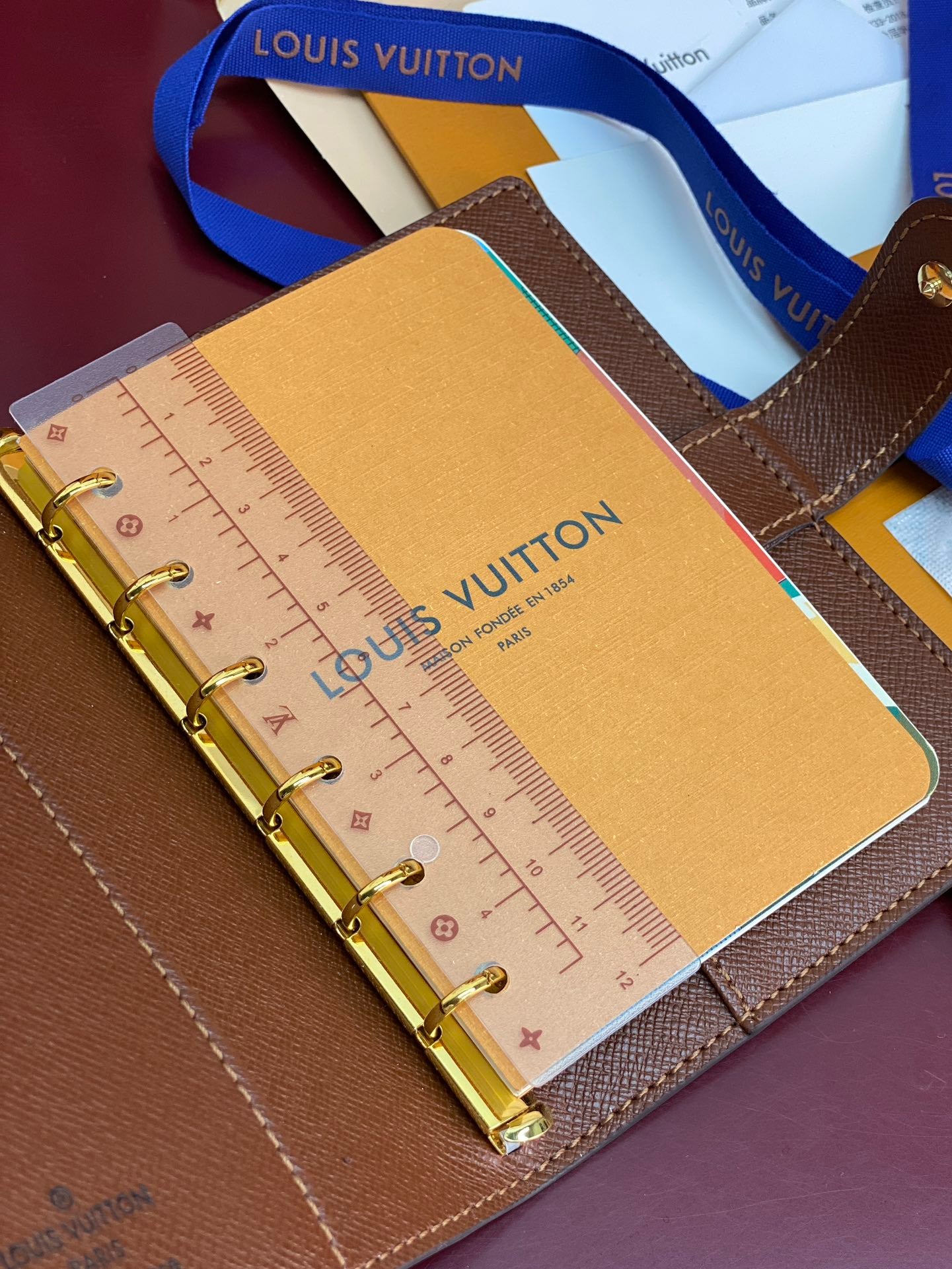 Brown Louis Vuitton small bag with ruler page insert and gold ring binder