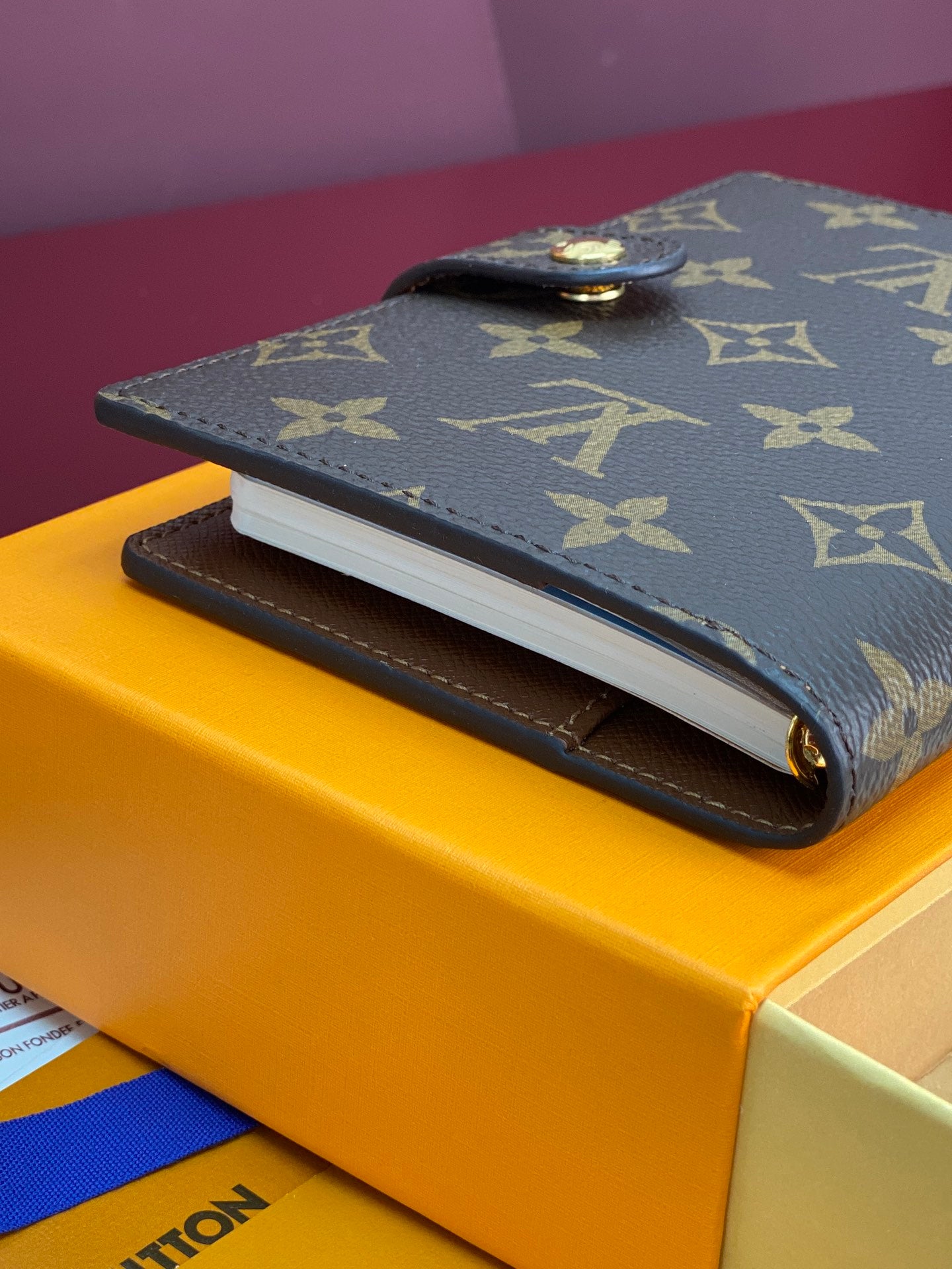 Louis Vuitton monogram small bag with gold-tone snap on dark canvas