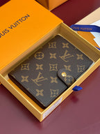 Brown Louis Vuitton monogram small bag with snap closure, laid open