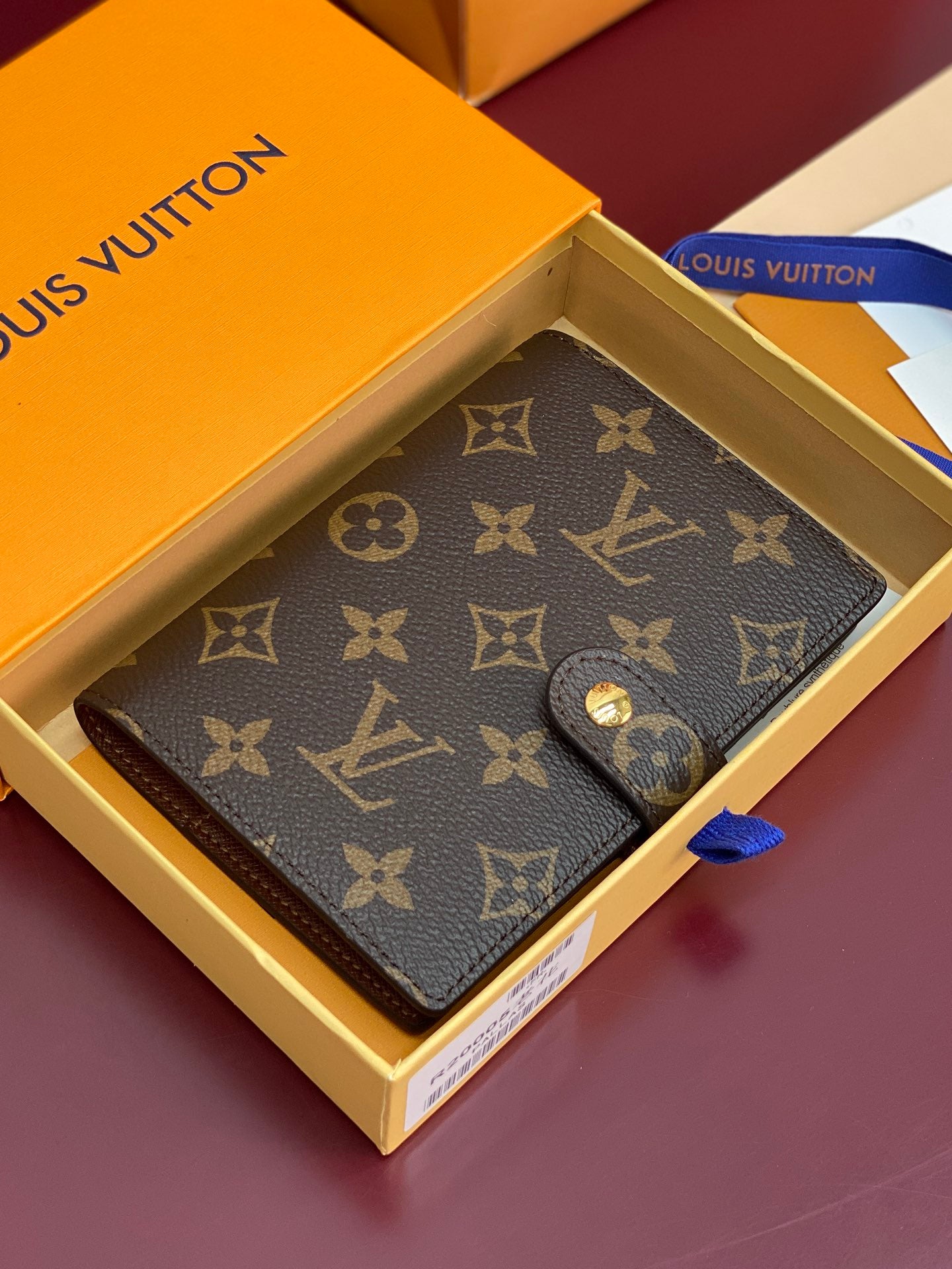 Brown Louis Vuitton monogram small bag with snap closure, laid open