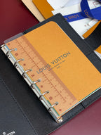 Louis Vuitton small bag, ring-bound planner with ruler insert on tan paper