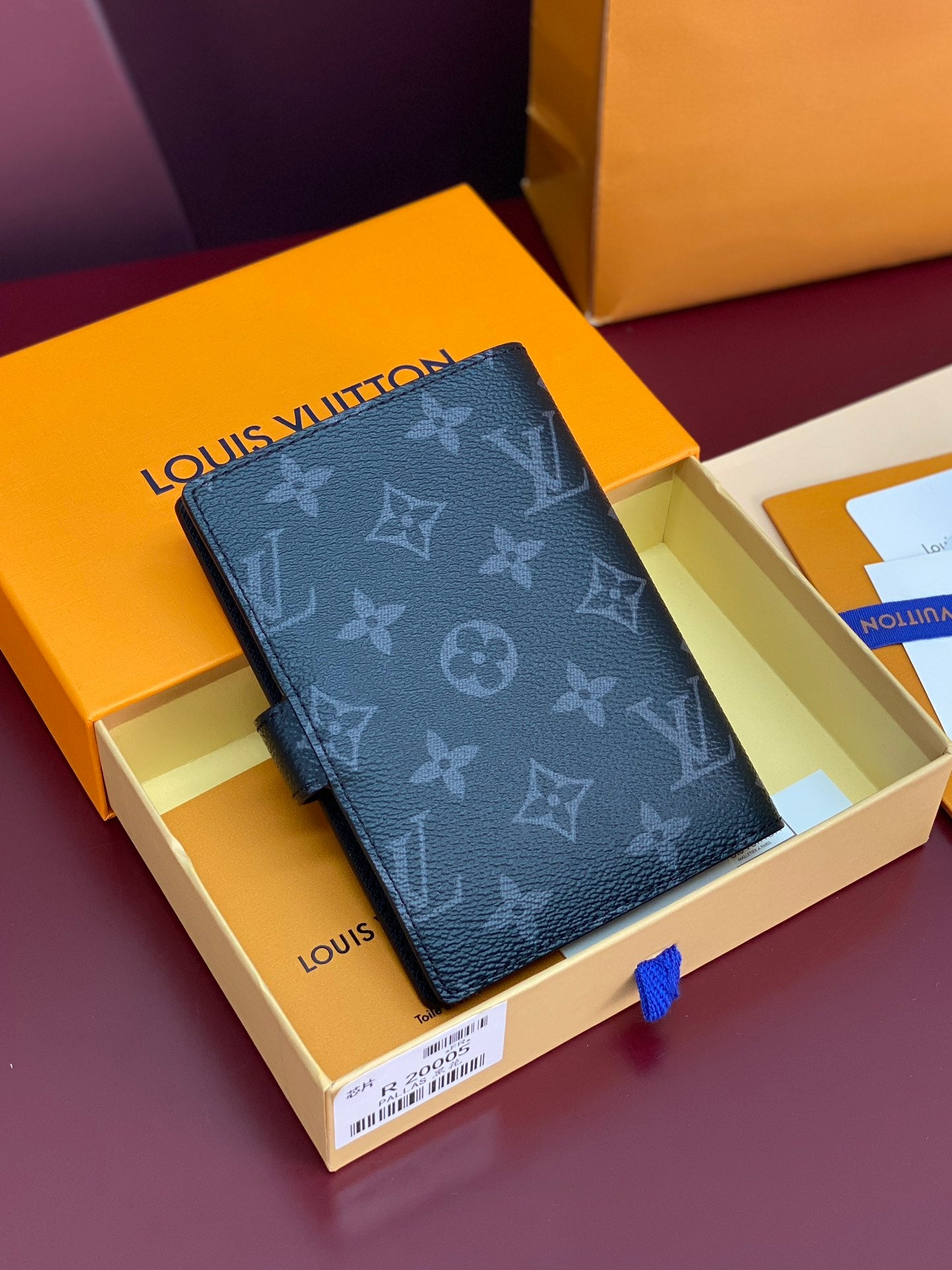 Louis Vuitton small bag, dark monogram cover with clasp and embossed pattern