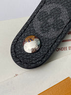 Black leather small bag with round Louis Vuitton snap button