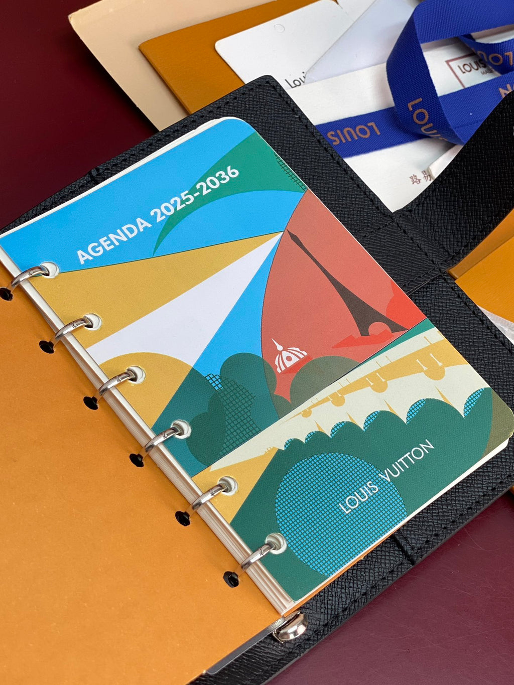Louis Vuitton small bag, agenda planner with colorful tabs and metal ring binding