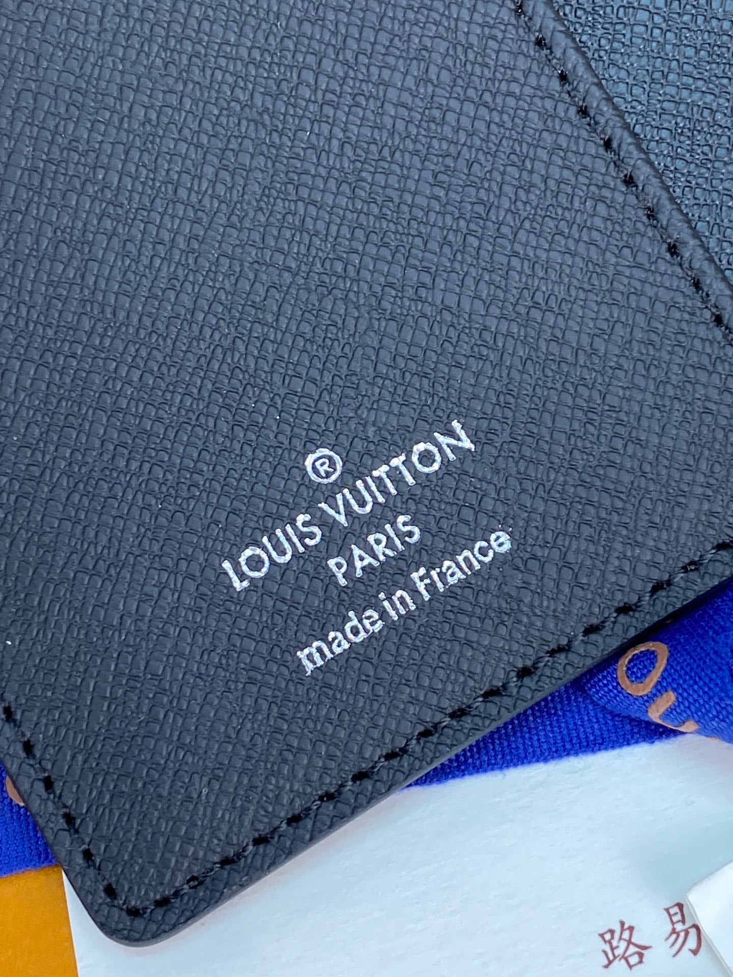 Louis Vuitton small bag, black leather label reading 'made in France'