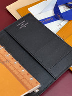 Louis Vuitton small bag, textured black folio cover with stitched flap