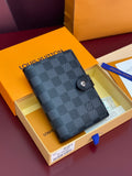 Louis Vuitton small bag in dark checkered canvas with snap button closure