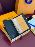 Louis Vuitton small bag opened, showing ruler-like organizer insert and snap button