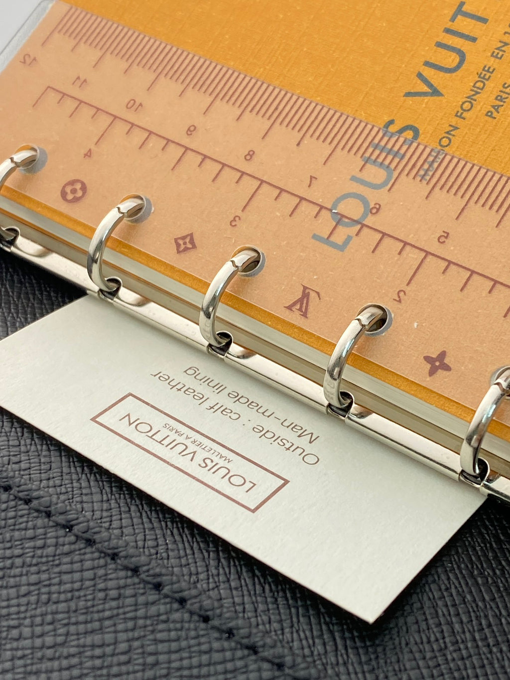 Small bag with metal ring binder and tan paper label insert