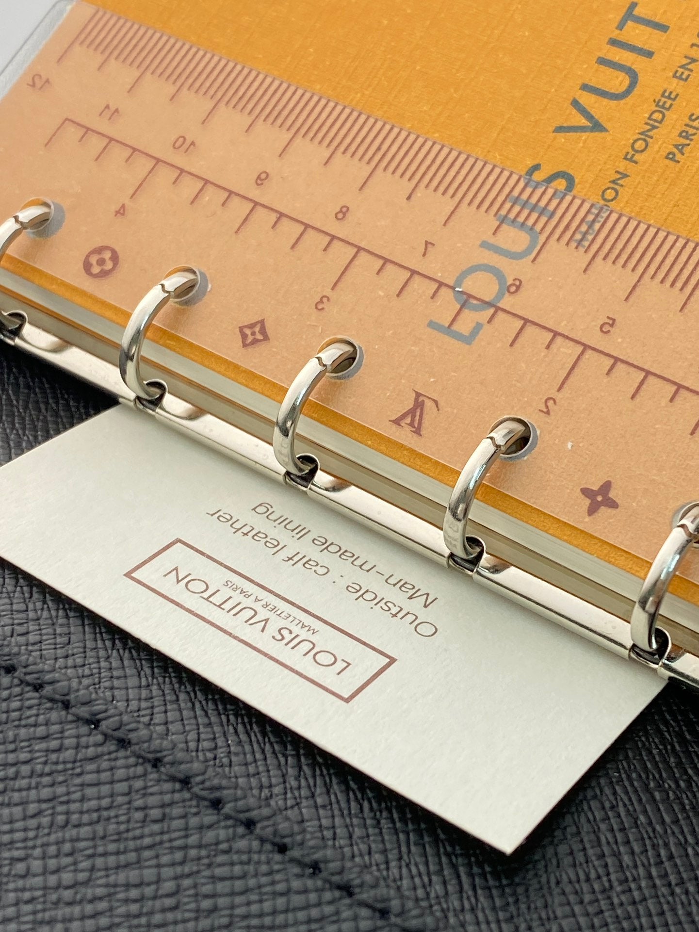 Small bag with metal ring binder and tan paper label insert