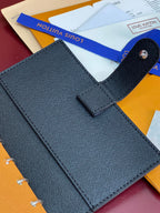 Louis Vuitton small bag front, textured dark fabric with snap pocket tab