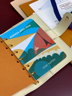 Ivory agenda planner cover with colorful printed pages in small ring binder