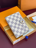 White and gray checkered small wallet bag with snap button closure and gold hardware