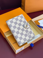 White and gray checkered small wallet bag with snap button closure and gold hardware