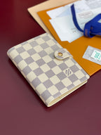 Checkered small wallet bag with snap button front and textured fabric with gold clasp