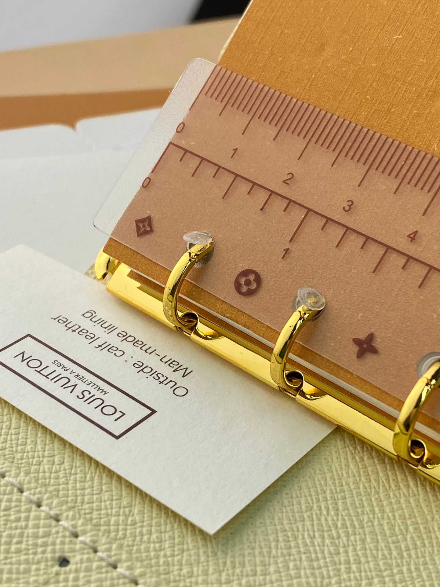 Small bag clasp with gold hardware and two ring posts on tan leather