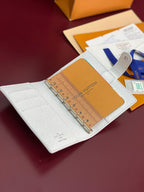 Small bag open with ring binder, tan insert, and multiple card slots in light color.