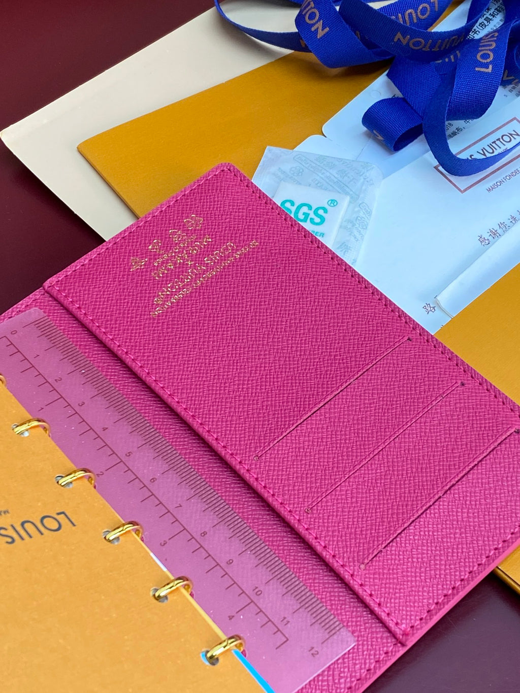 Small bag planner with magenta cover and SGS tag on an open insert