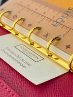 Small bag with cream monogram canvas and gold rings, red leather base