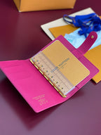 Small bag planner with magenta leather cover, open rings, tan insert with printed text