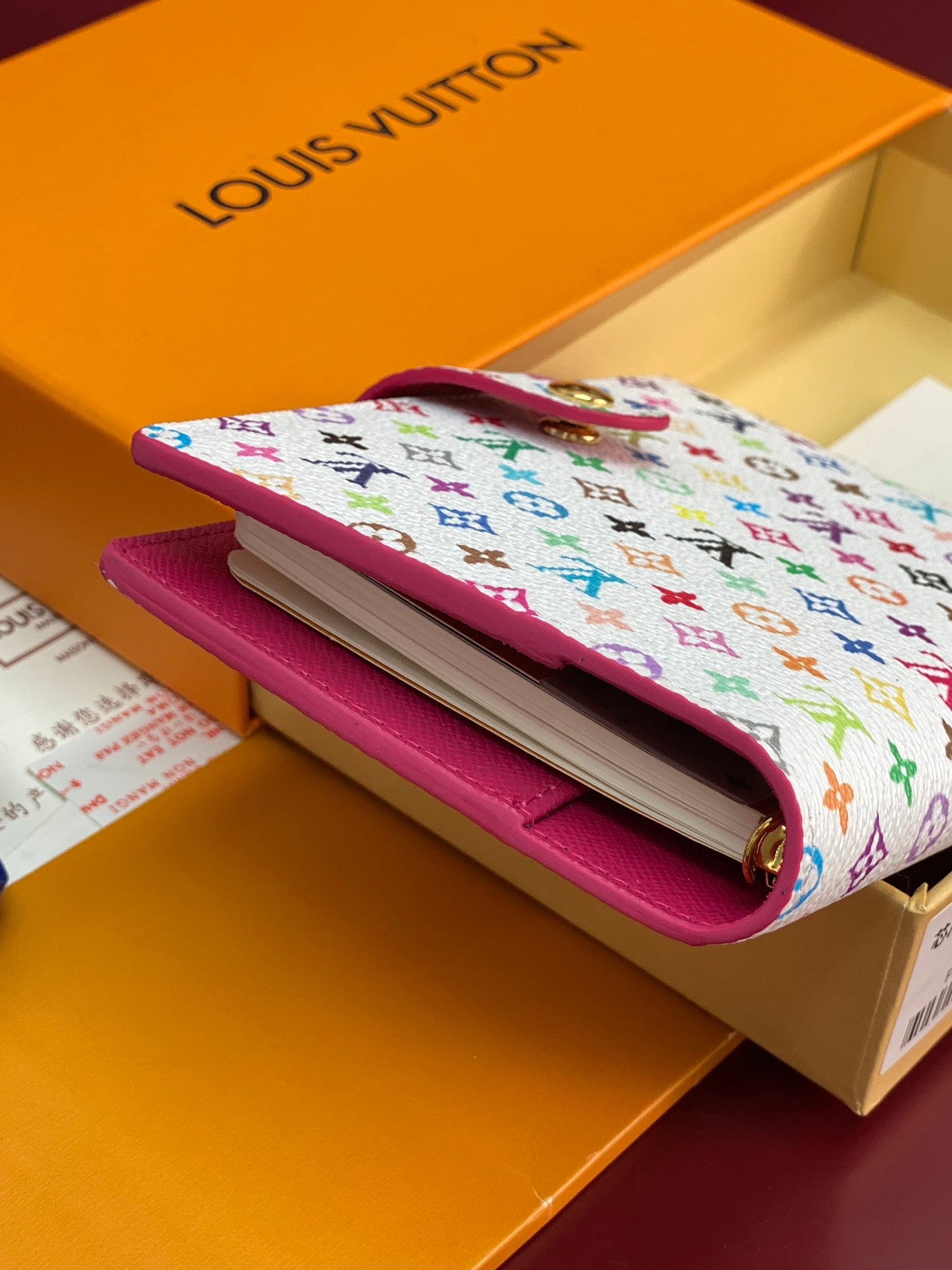 Small bag with multicolor canvas and pink leather, folded flap open