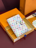 Small bag with white multicolor monogram canvas and pink trim, front flap closed