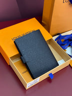 Louis Vuitton small bag, dark blue textured finish, front flap and snap closure
