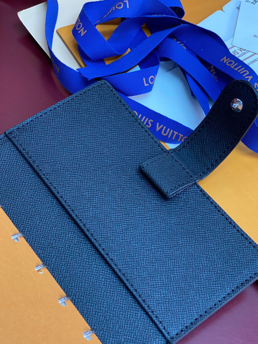 Louis Vuitton small bag, dark blue leather with top handle and front snap tab