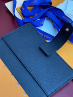 Louis Vuitton small bag, dark blue leather with top handle and front snap tab