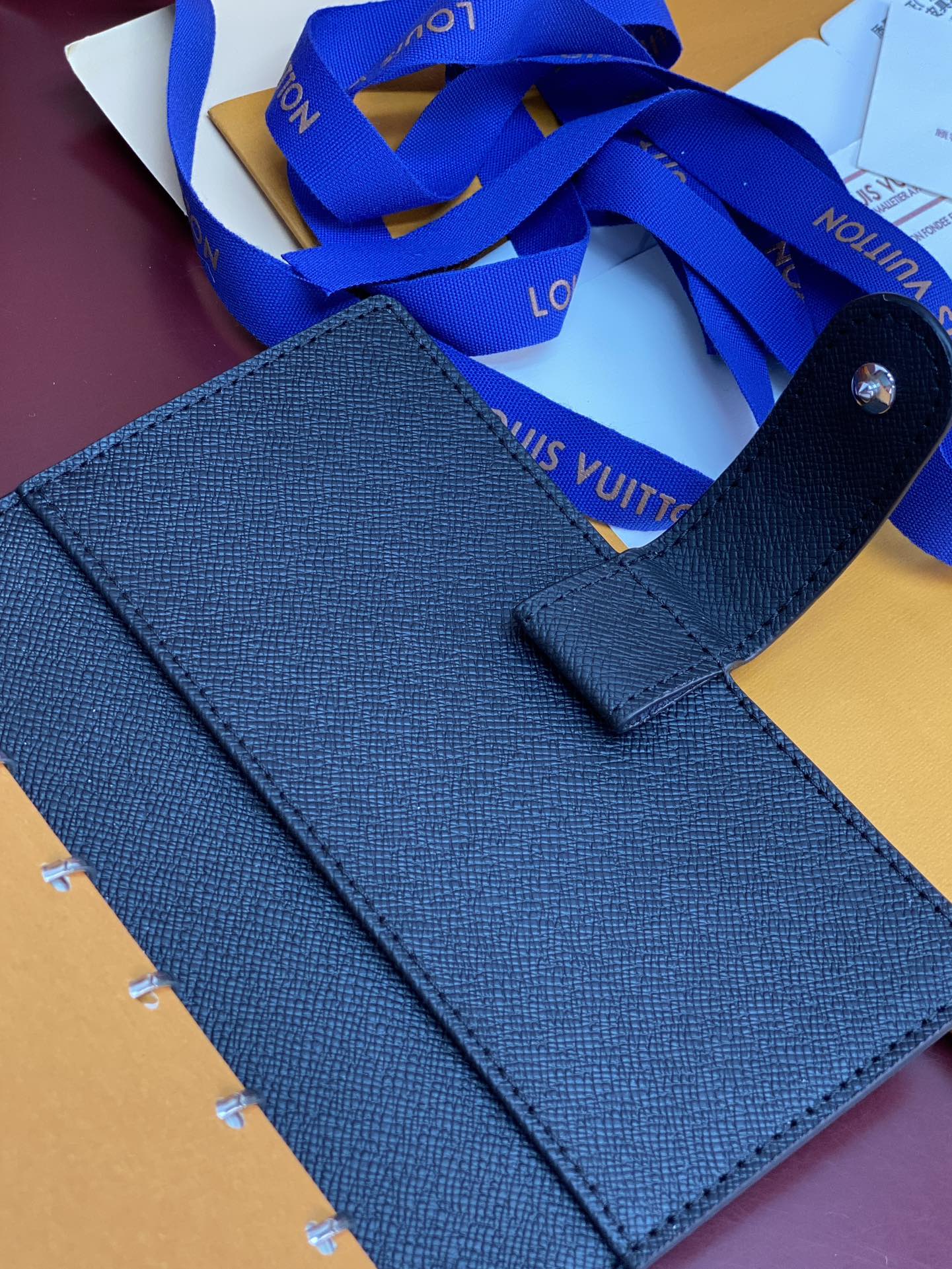 Louis Vuitton small bag, dark blue leather with top handle and front snap tab
