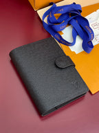 Louis Vuitton small bag, dark blue textured leather, front flap with button closure