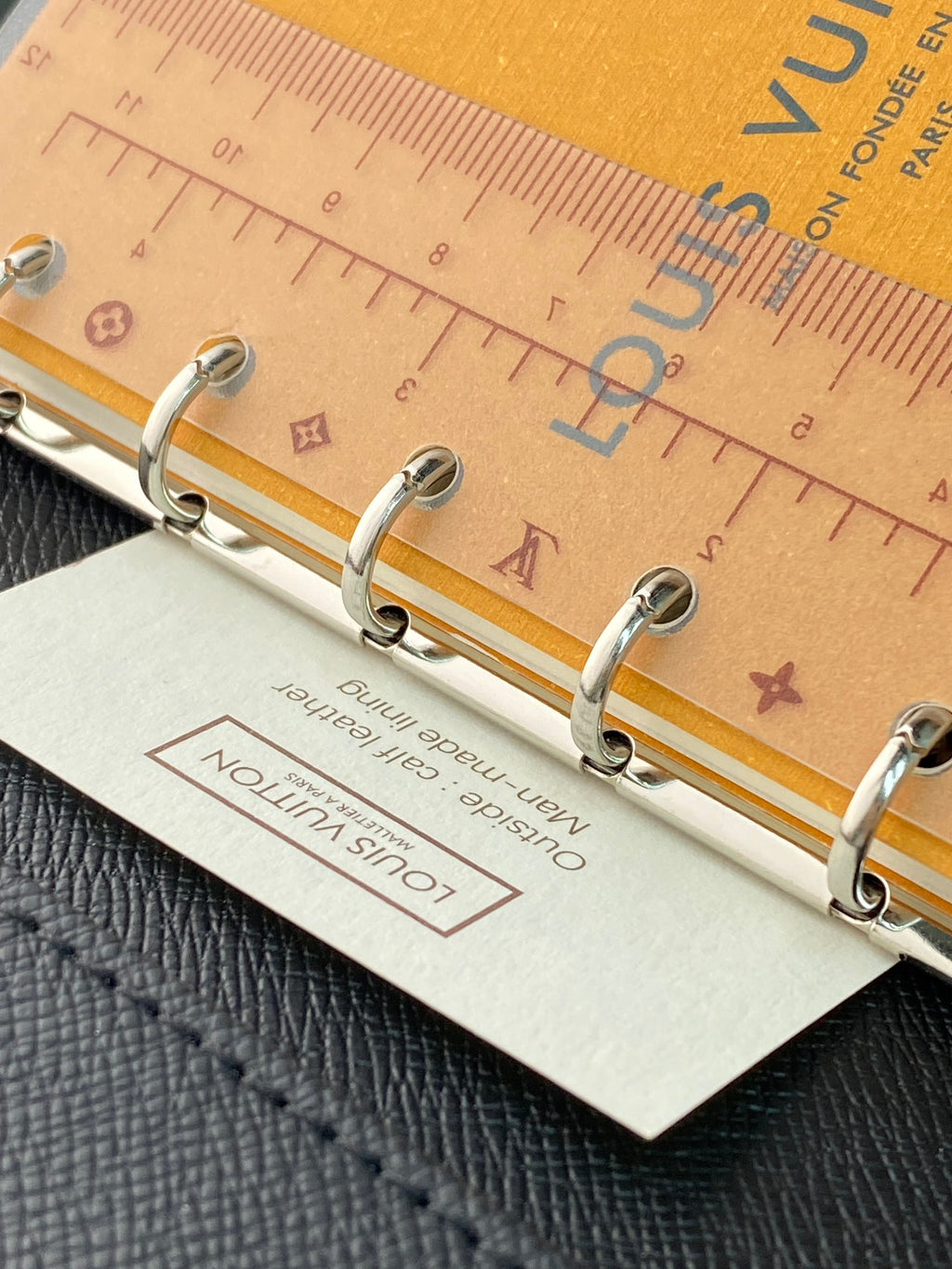 Small bag with metal ring binder and light tan leatherette exterior