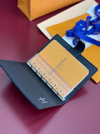 Louis Vuitton small bag open, navy leather with tan interior and ruler insert inside.