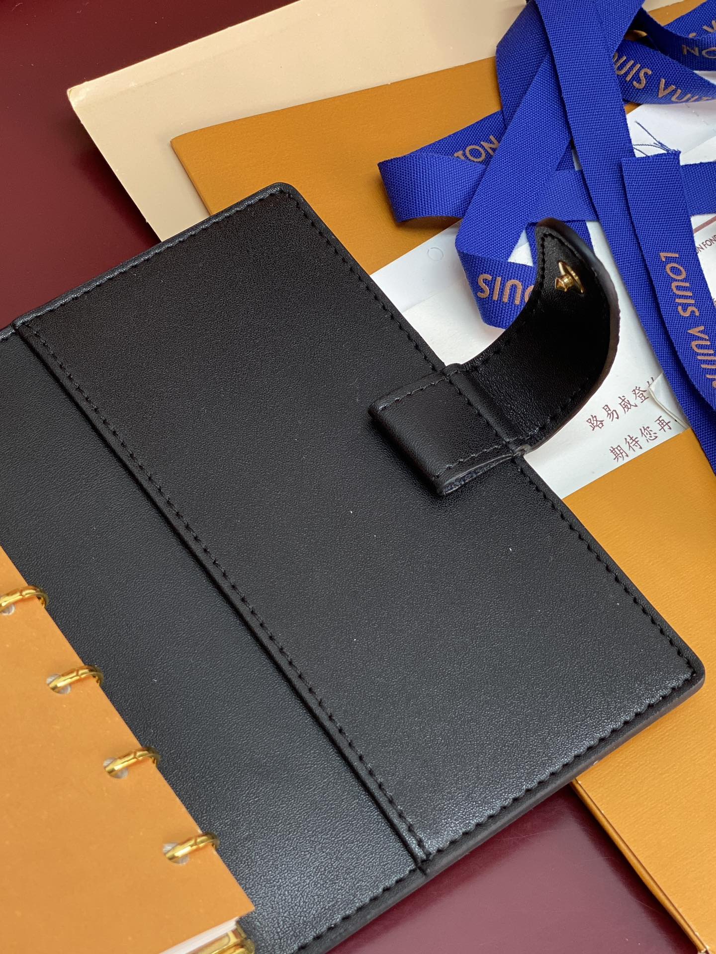Small Louis Vuitton leather agenda with strap and blank cover, dark blue