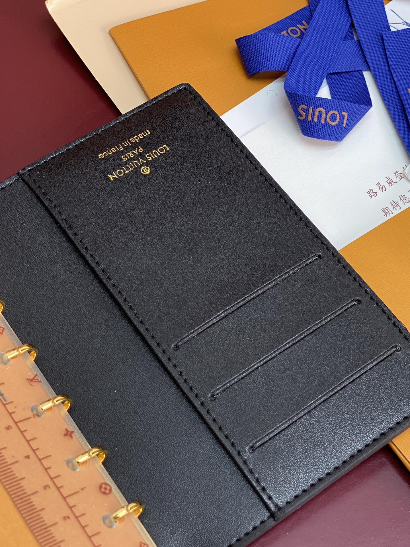 Small Louis Vuitton leather card slots page, dark blue, open