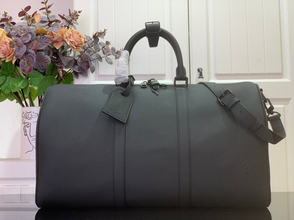Louis Vuitton leather duffel bag in dark gray with top handles and shoulder strap