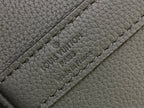 Louis Vuitton Paris text embossed on leather strap panel close-up