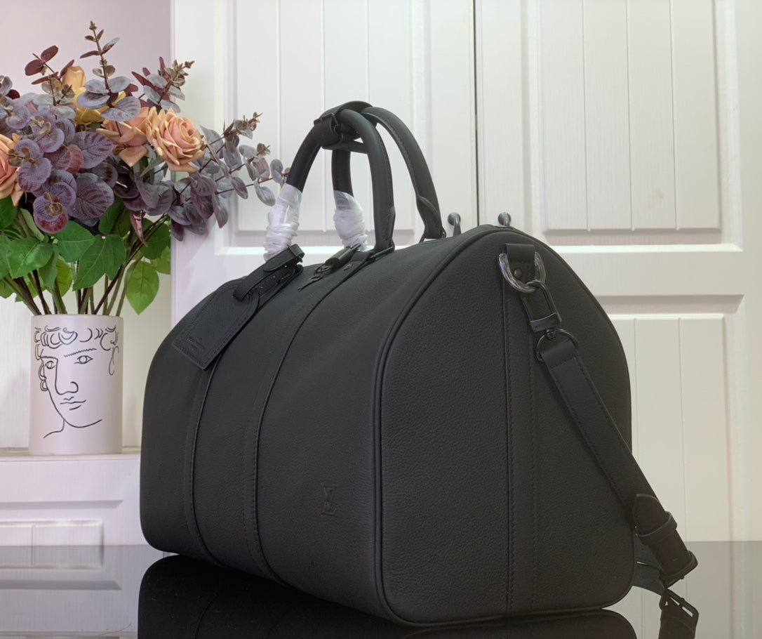 Louis Vuitton men’s duffel bag with adjustable shoulder strap and side detailing
