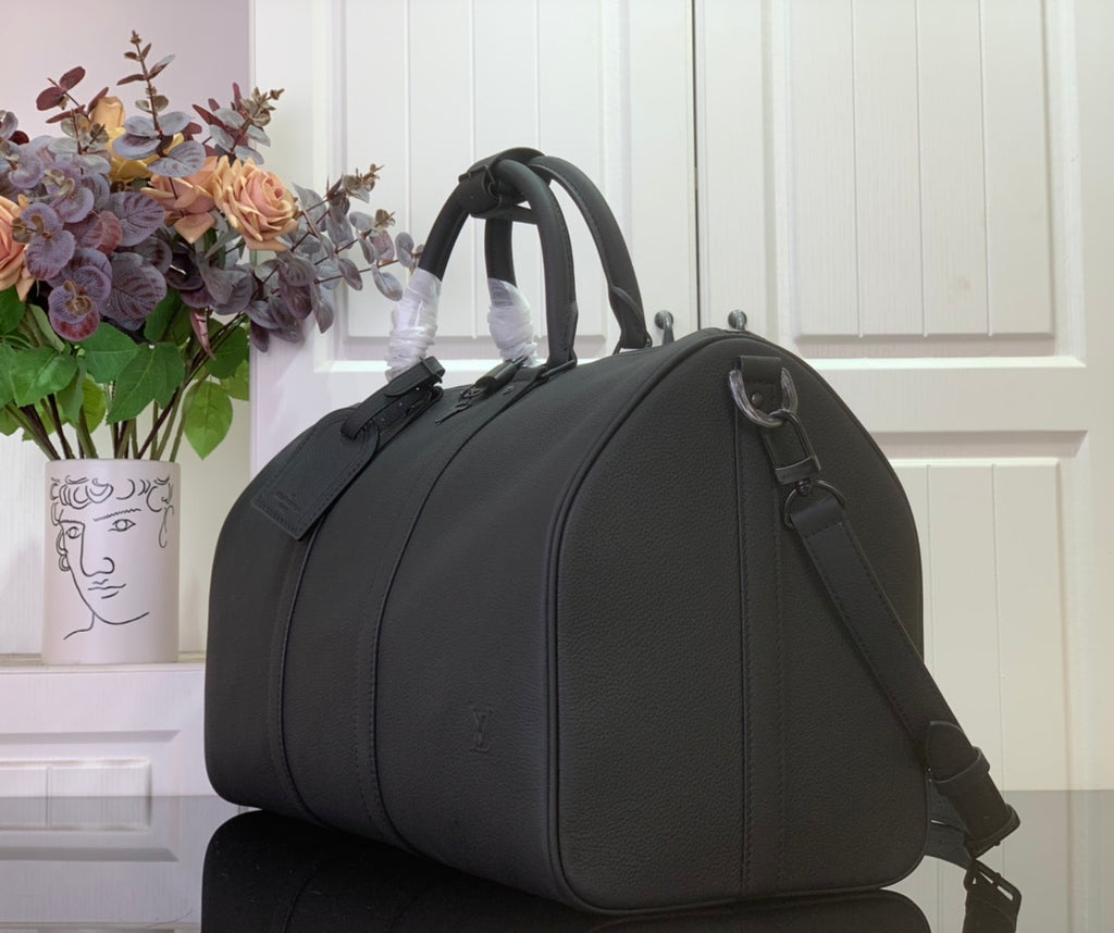 Louis Vuitton leather duffel bag angled view with top handle and crossbody strap