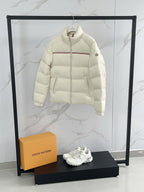 Moncler cream puffer jacket side view, quilted panels and zip front
