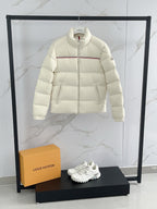 Moncler cream puffer jacket front, full zip with red stripe across chest
