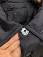 Prada long-sleeve jacket neck label and round button close-up